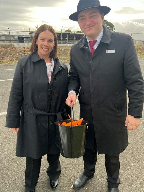 Tuckers funeral directors holding a bucket of carrots