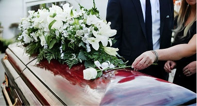 flower arrangement on top of a coffin