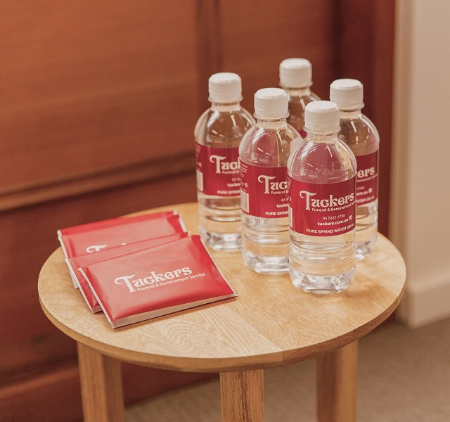 tissue and bottled water on top of a table