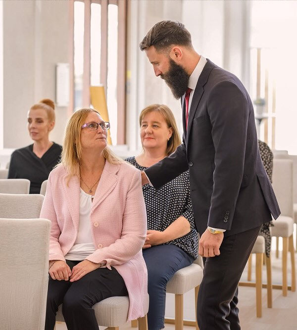 Tuckers funeral director with people at chapel