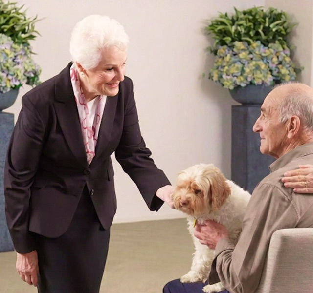 Tuckers funeral director with man and dog in chapel